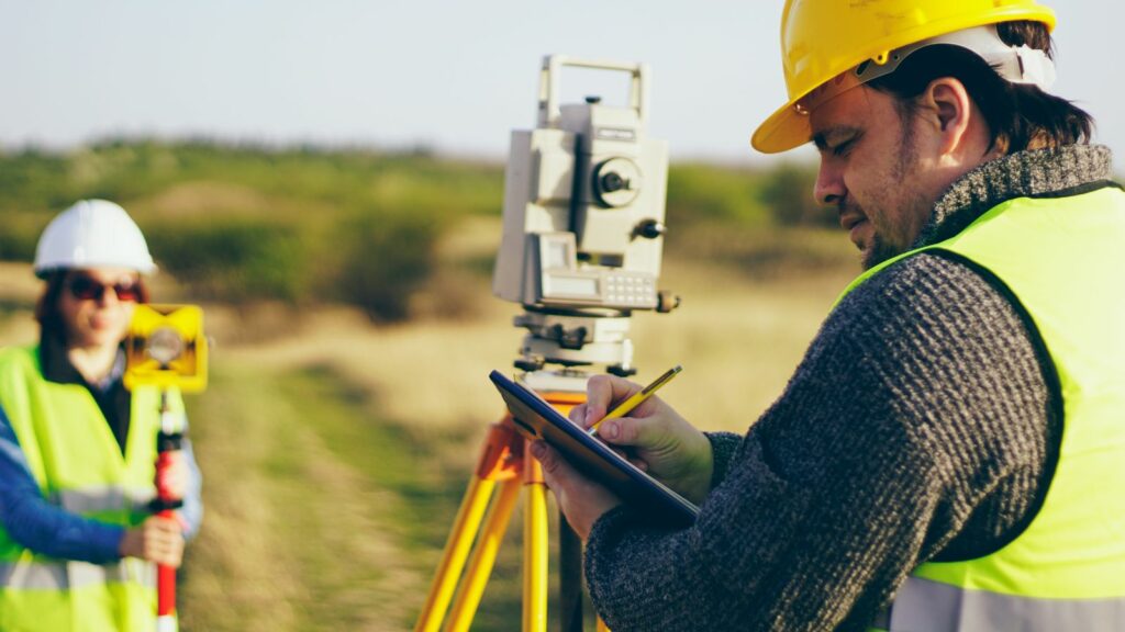 Two man surveying a land.